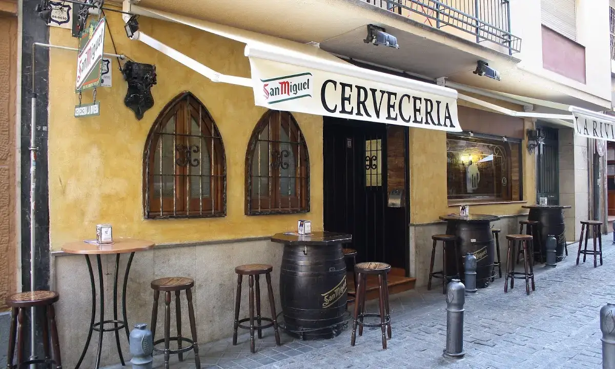 Interior of La Riviera Granada bar with eclectic decor and suit of armour