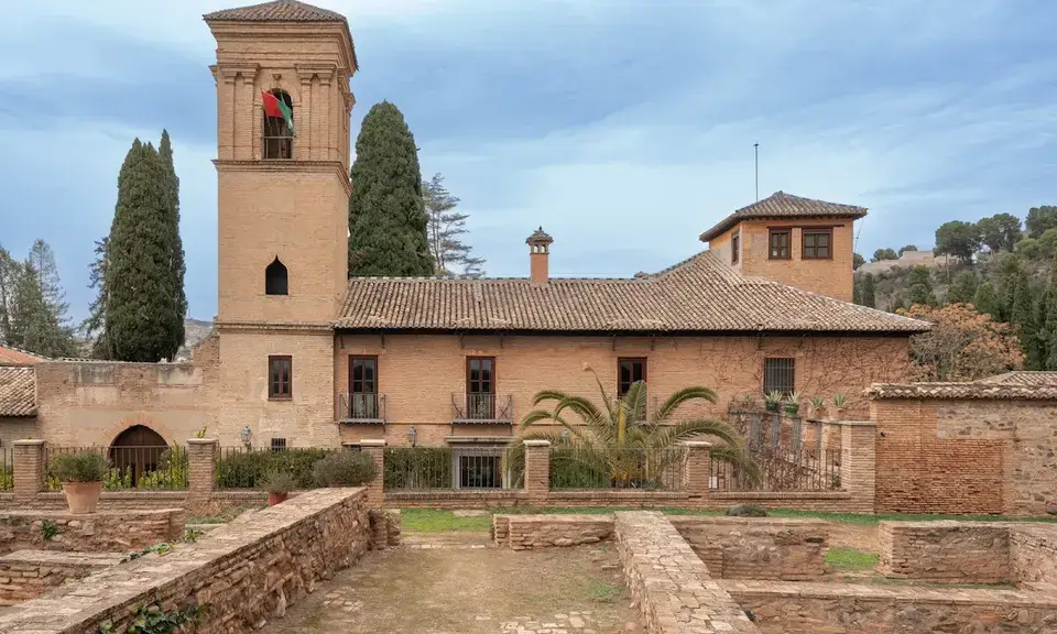 Parador de Granada cloister with Nasrid arches and orange trees inside the Alhambra complex